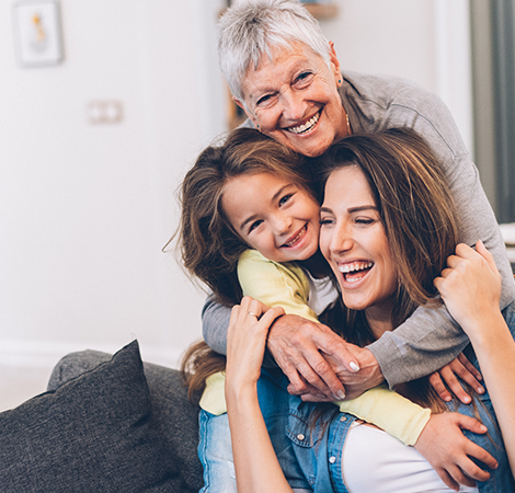 grandmother hugging daughter and grand daughter