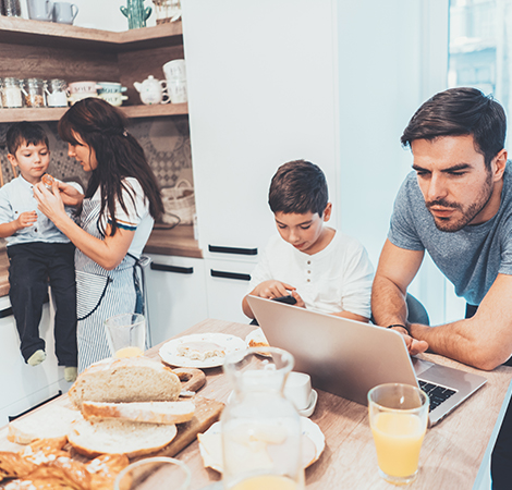 father and family using laptop