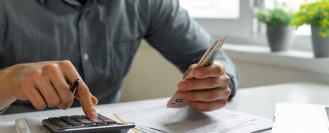 A man evaluates his cash and other assets.