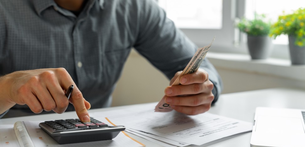 A man evaluates his cash and other assets.