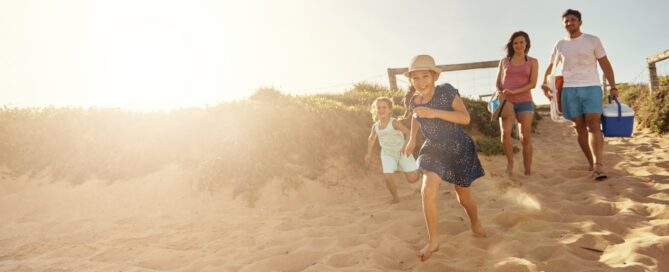A family arrives at the beach for their summer vacation.