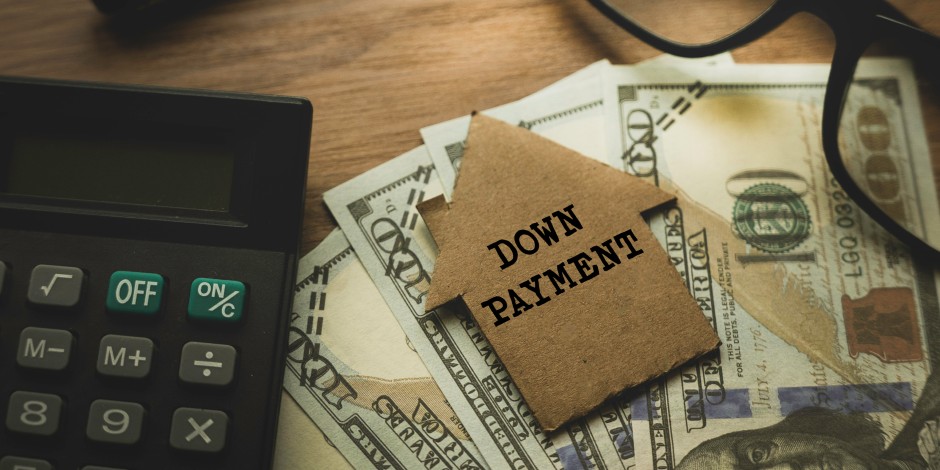 An illustration of a calculator and money, indicating how to save for a down payment on a house.