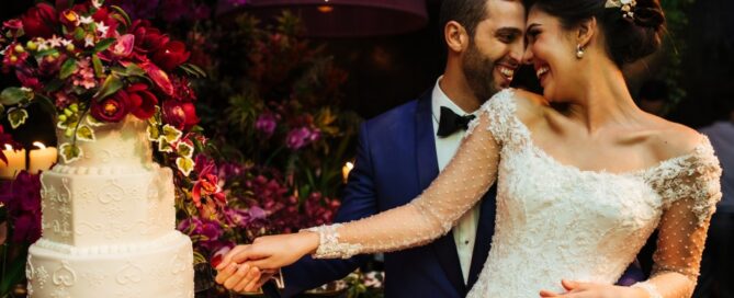 Newlyweds cut their wedding cake at an opulent celebration.