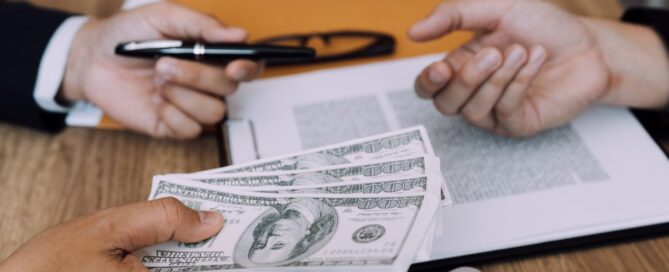 A borrower is about to sign for a stack of money.