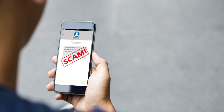 A phone indicates a message is a scam.